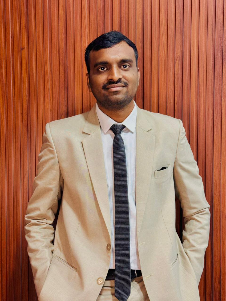 Dr. Yakhub Mohammed in cream suit